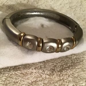 Silver bracelet with three big clear stones and gold rims